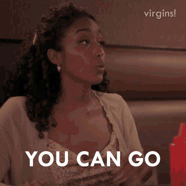 a woman sitting in a booth with the words " you can go " in front of her