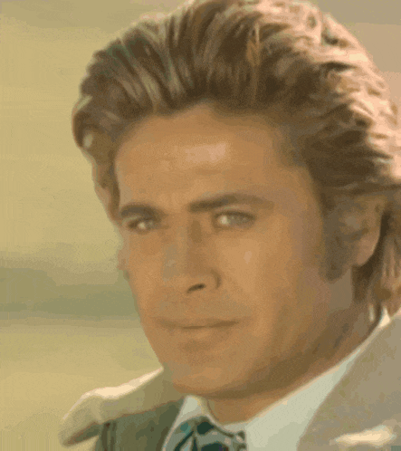 a close up of a man 's face with a serious look on his face
