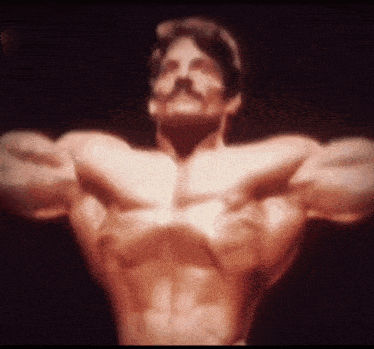 a man with a mustache is showing off his muscles