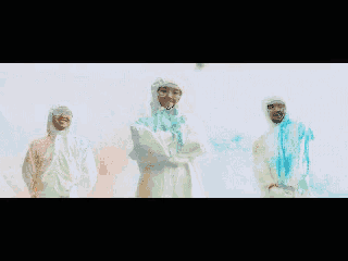 a group of people covered in colored powder standing next to each other