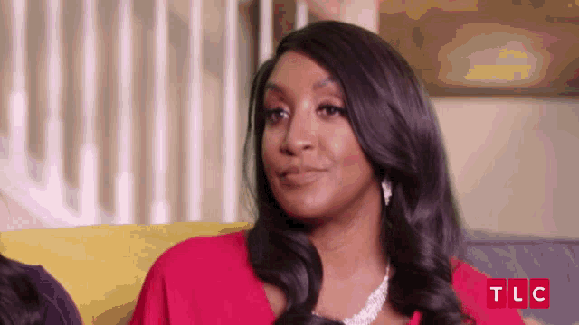 a woman sitting on a couch with tlc written in red letters