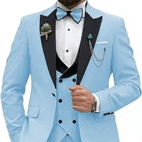 a man is wearing a light blue tuxedo with a black collar and a bow tie .