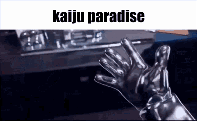 a person wearing a pair of silver gloves is waving at the camera .