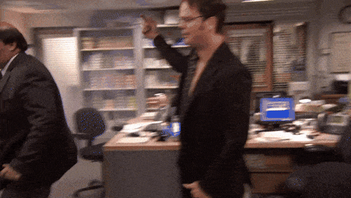 a man in a suit is pointing at something