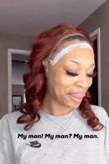 a woman with red hair is wearing a nike shirt and making a funny face .