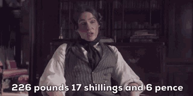 a man in a suit is sitting in a chair with the words 226 pounds 17 shillings and 6 pence on the screen .