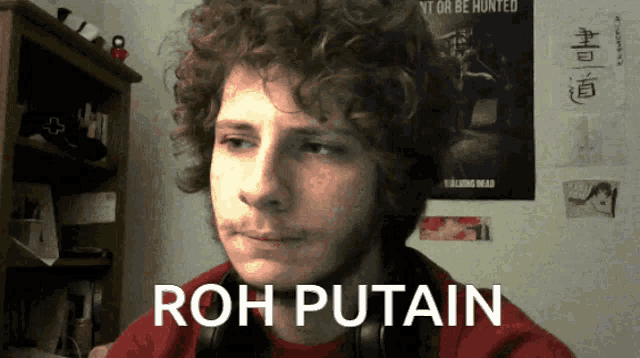 a man with curly hair says roh putain on his face