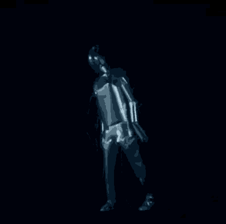 a robot is standing in the dark with a helmet on his head