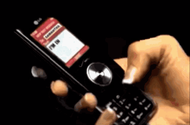 a person is holding a cell phone with a message on the screen that says i 'm in t
