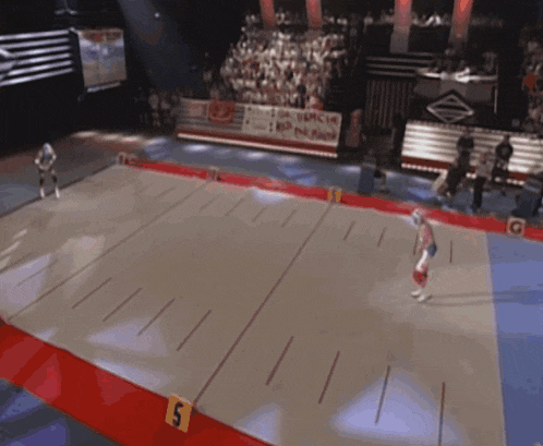 a hockey game is being played on a rink with the number 5 on the side