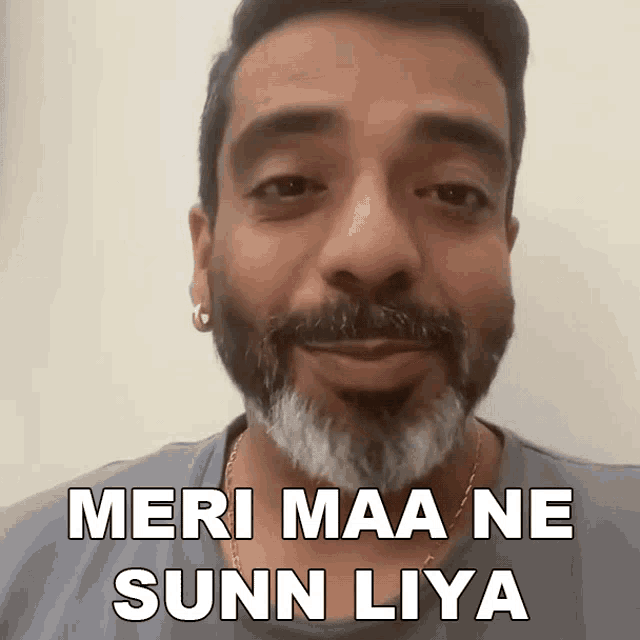 a man with a beard is smiling and says meri maa ne sunn liya