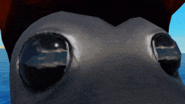a close up of a shark 's eyes with a blue sky in the background
