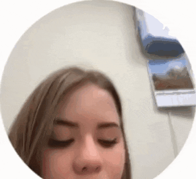 a close up of a woman 's face in a circle .