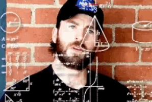 a man with a beard is standing in front of a brick wall with a bunch of mathematical equations on it .
