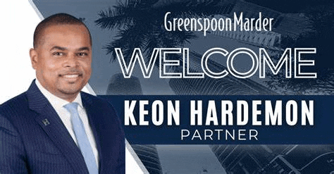 a man in a suit and tie is standing in front of a sign that says `` welcome keon hard demon partner '' .