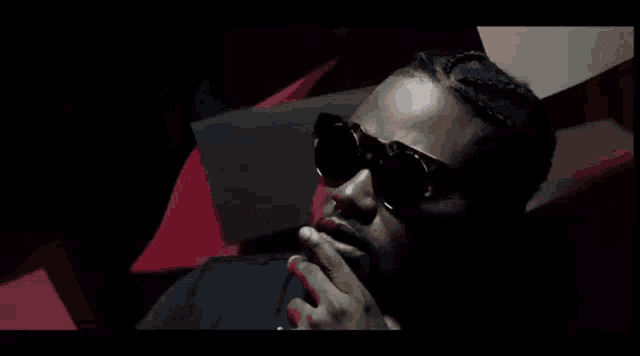 a man with sunglasses and a ring on his finger