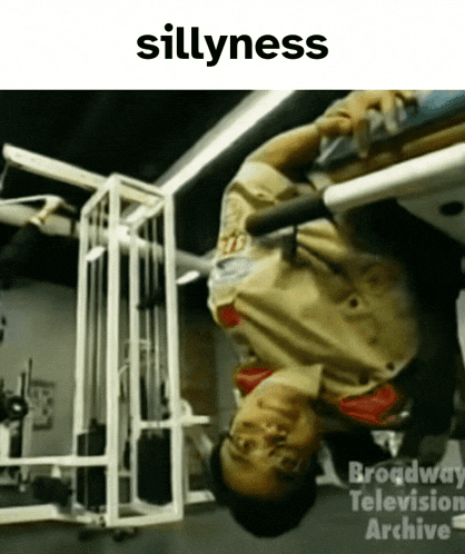 a man is upside down in a gym and the word sillyness is on the bottom
