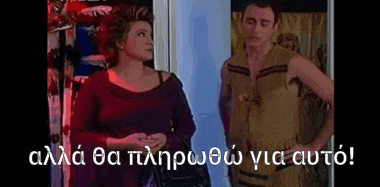 a man in a native american outfit is standing next to a woman in a red shirt .