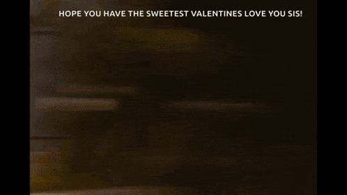 a blurry picture of a woman holding a box of valentine 's day candy .