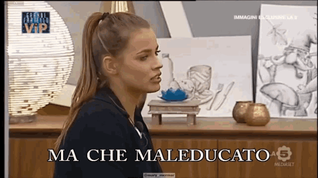 a woman says ma che maleducato in front of a table