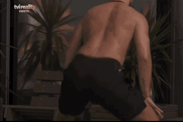 a group of people are dancing in front of a tv that says tv reality