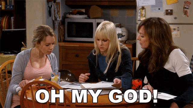 three women sitting at a table with the words oh my god written on it
