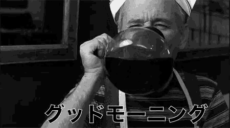 a black and white photo of a man drinking a cup of coffee from a coffee pot .