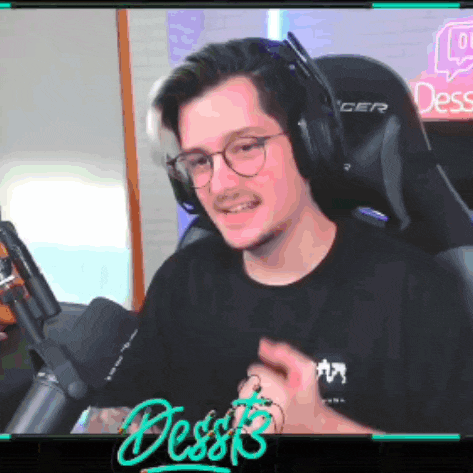 a man wearing headphones and glasses is sitting in front of a microphone with a neon sign that says desserts