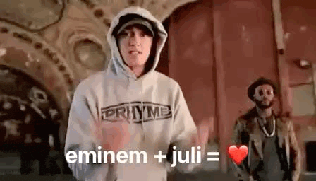 eminem and juli are standing next to each other in a room .
