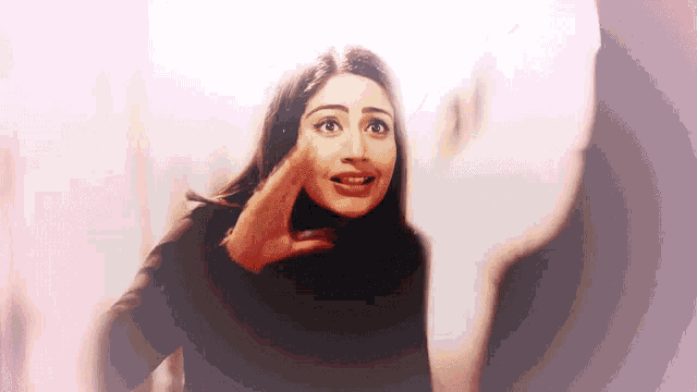 a woman with a surprised look on her face is wearing a black turtleneck