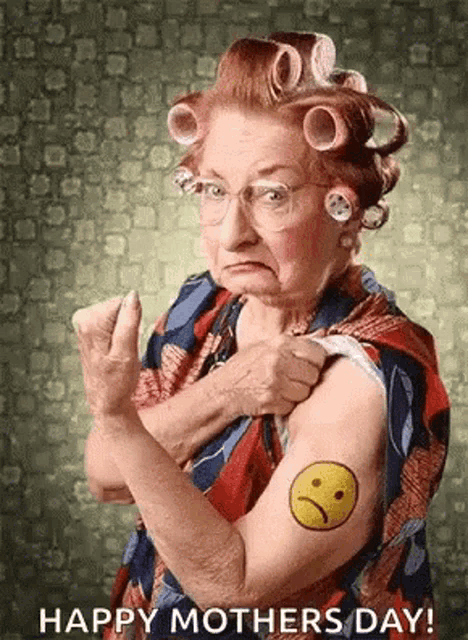 an elderly woman with curlers on her hair has a tattoo of an angry face on her arm