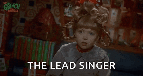 a little girl in a wig is saying the lead singer in a christmas movie .