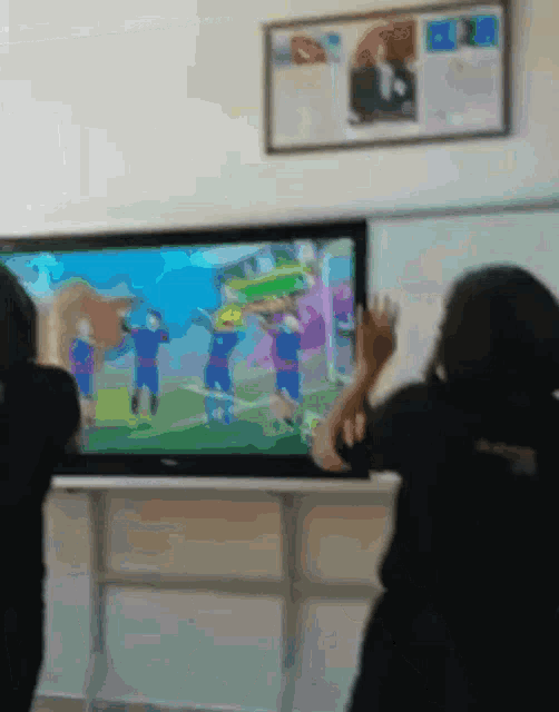 a group of children are watching a cartoon on a large screen