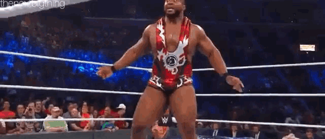 a man in a red and white outfit is standing in a boxing ring .