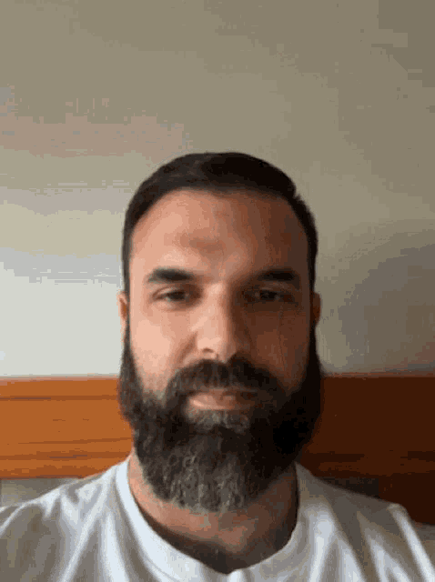 a man with a beard wearing a white shirt