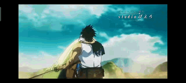 a man in a white shirt is holding a sword in front of a mountain .