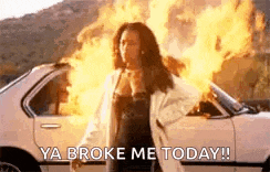 a woman is standing in front of a car that is on fire and says `` ya broke me today ! ''