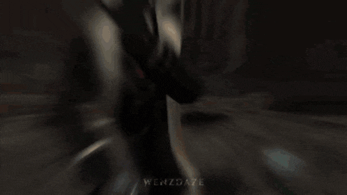 a man in a suit and tie is holding a gun in front of a screen that says enzdaze