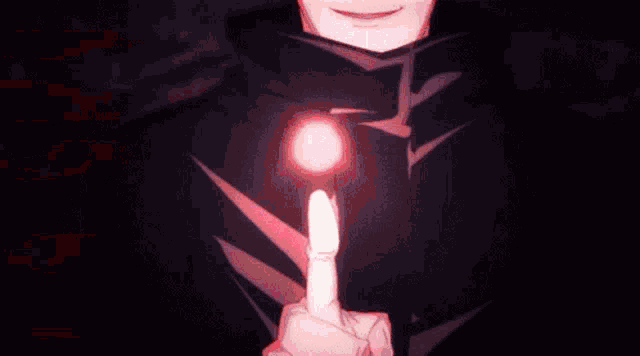 a close up of a person 's hand holding a red light in the dark .