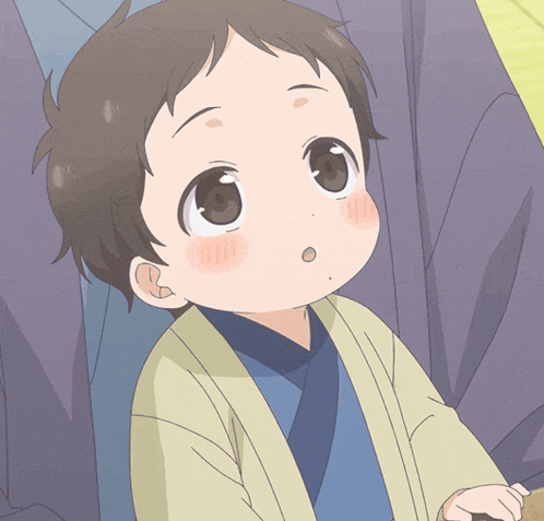 a little boy with a surprised look on his face is wearing a blue shirt