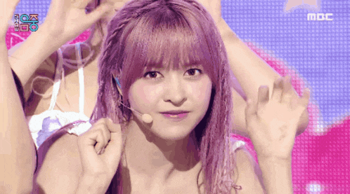 a girl with purple hair and a microphone on her head