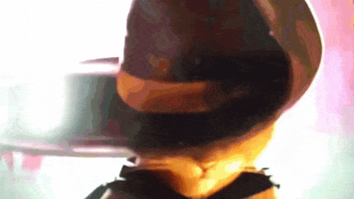 a close up of a person wearing a hat and a bow tie