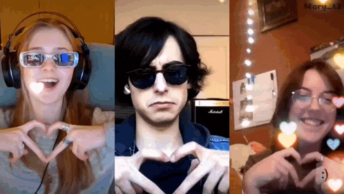 three people are making hearts with their hands in front of a marshall amp