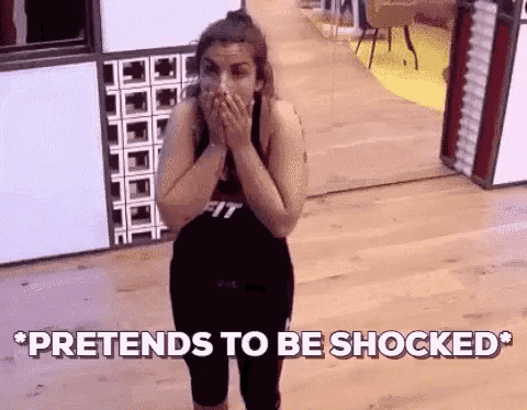 a woman is covering her mouth with her hands and the words pretends to be shocked are above her .
