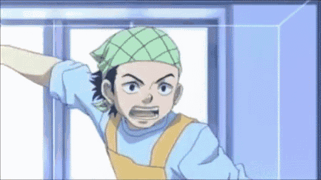 a boy with a green bandana on his head is standing in front of a door