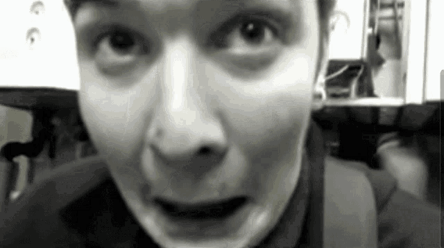 a close up of a person 's face with a surprised expression
