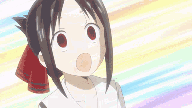 a girl with a red bow in her hair is making a surprised face .