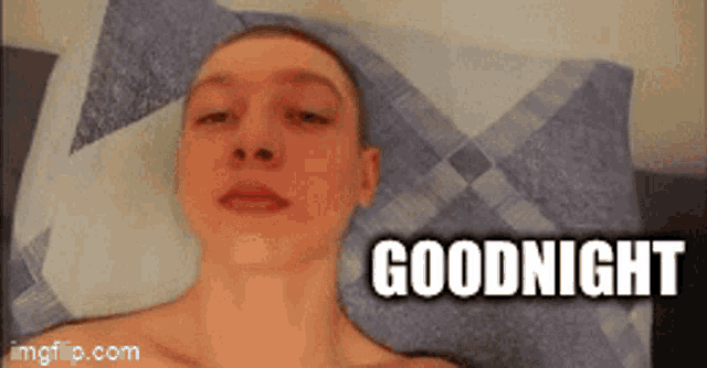 a shirtless man is laying on a bed with the words goodnight above his head