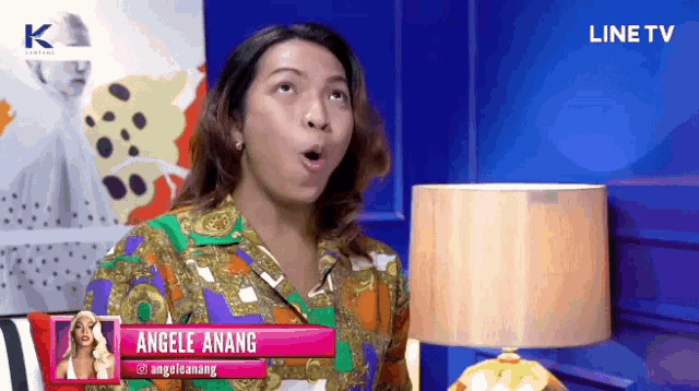 a woman with a name tag that says angele anang on it