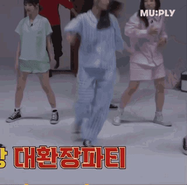 a group of women are dancing together in a room .